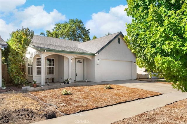 1057 Windsor Way, Chico, CA 95926 - ranch-style house featuring stucco siding, covered porch, driveway, a garage, and a shingled roof
