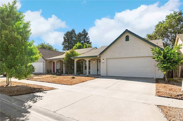 1057 Windsor Way, Chico, CA 95926 - ranch-style home with stucco siding, an attached garage, driveway, and covered porch