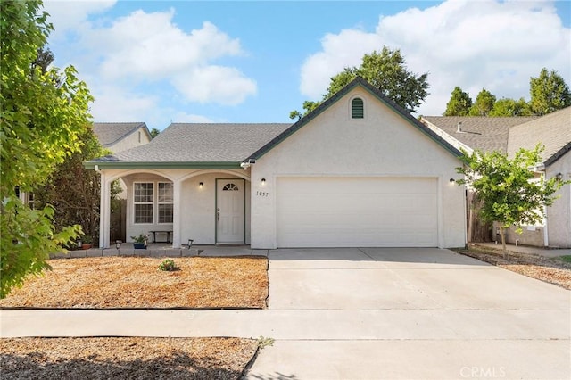 1057 Windsor Way, Chico, CA 95926 - view of front facade with a garage, stucco siding, concrete driveway, and covered porch