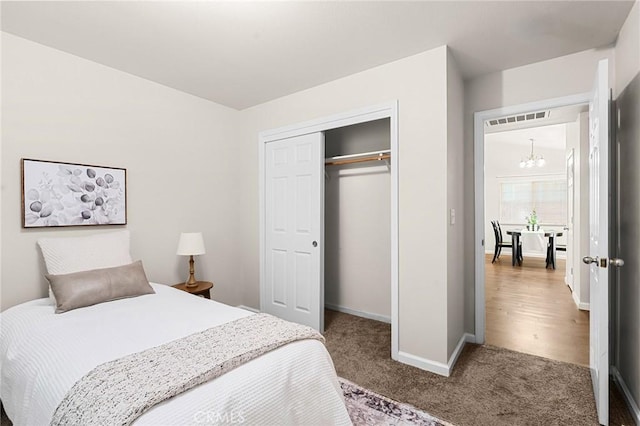 1057 Windsor Way, Chico, CA 95926 - bedroom with a chandelier, carpet floors, and a closet
