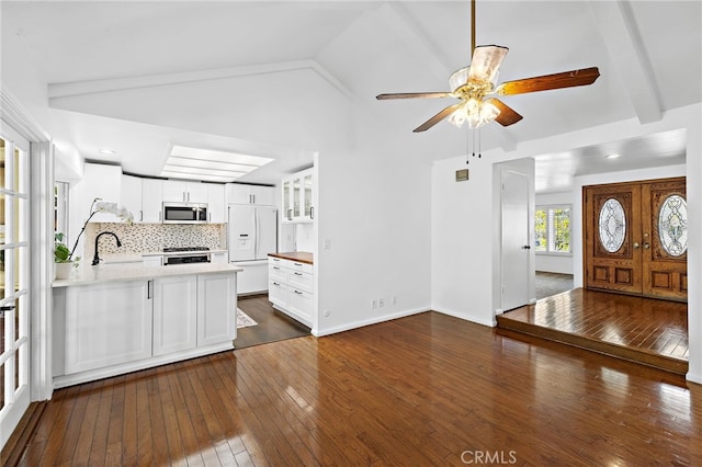 24802 La Plata Dr, Laguna Niguel, CA 92677 - kitchen with stainless steel microwave, ceiling fan, dark wood-style flooring, vaulted ceiling, and white cabinets