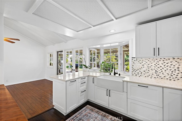 24802 La Plata Dr, Laguna Niguel, CA 92677 - kitchen featuring a peninsula, tasteful backsplash, healthy amount of natural light, white cabinets, and recessed lighting