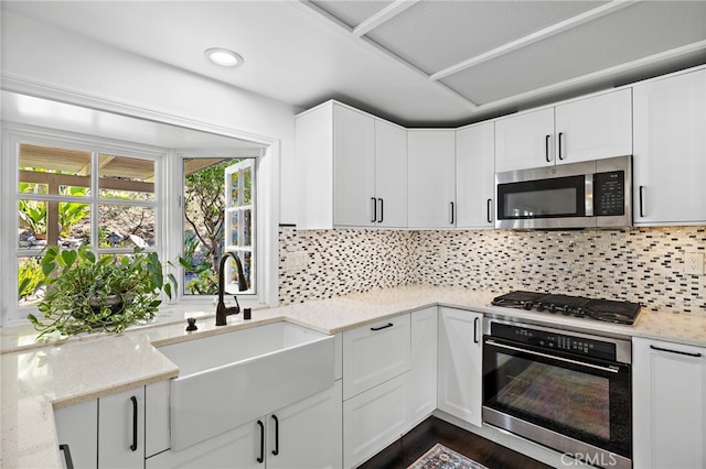 24802 La Plata Dr, Laguna Niguel, CA 92677 - kitchen with appliances with stainless steel finishes, light stone countertops, backsplash, white cabinets, and recessed lighting