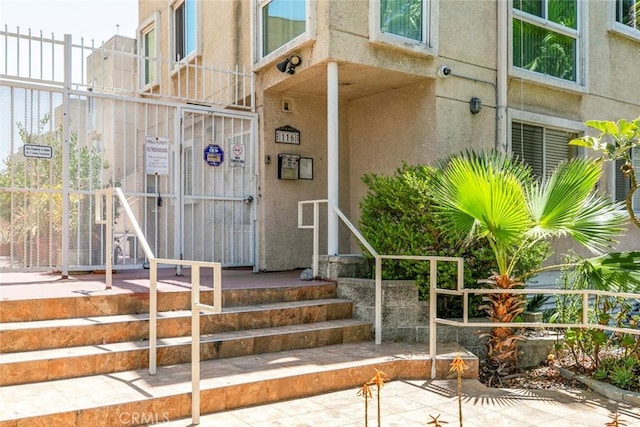 116 W Maple St Unit 25, Glendale, CA 91204 - property entrance with stucco siding and a surveillance system