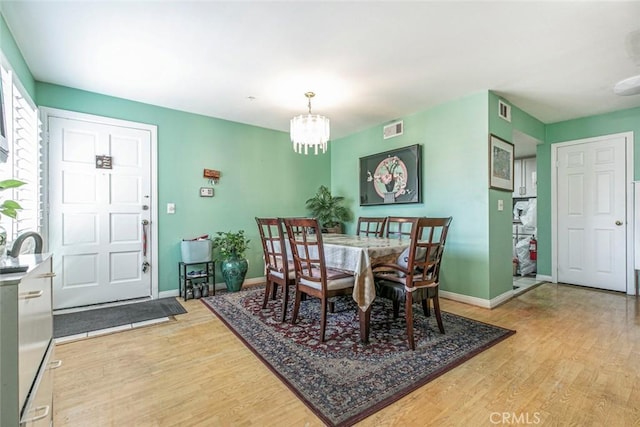 116 W Maple St Unit 25, Glendale, CA 91204 - dining room with light wood-style floors and a chandelier