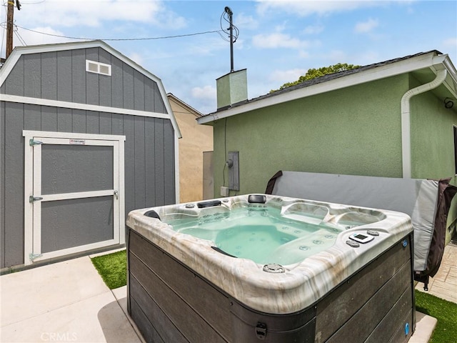 5243 E Monlaco Rd, Long Beach, CA 90808 - view of patio / terrace with a hot tub and a storage shed