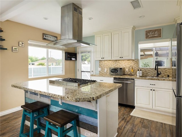 5243 E Monlaco Rd, Long Beach, CA 90808 - kitchen featuring stainless steel appliances, island exhaust hood, dark wood-style floors, backsplash, and light stone countertops