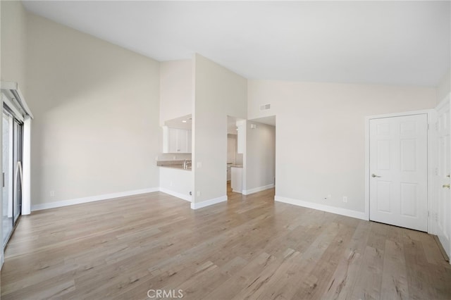 17842 Beard Ln Unit 88, Huntington Beach, CA 92647 - unfurnished living room with high vaulted ceiling and light wood-type flooring