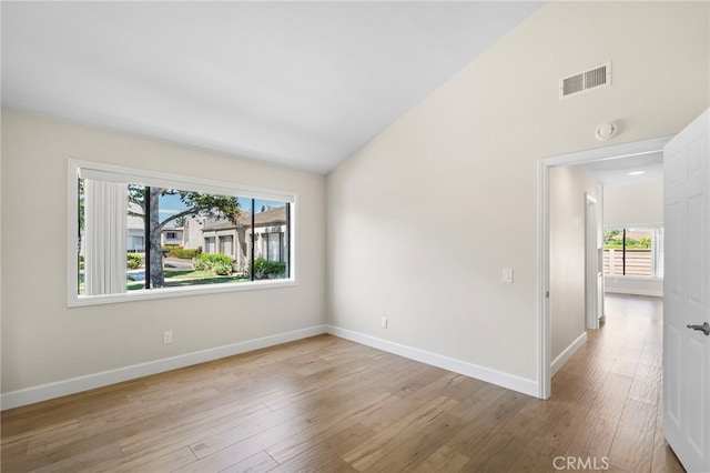 17842 Beard Ln Unit 88, Huntington Beach, CA 92647 - spare room with a smoke detector, wood finished floors, and high vaulted ceiling