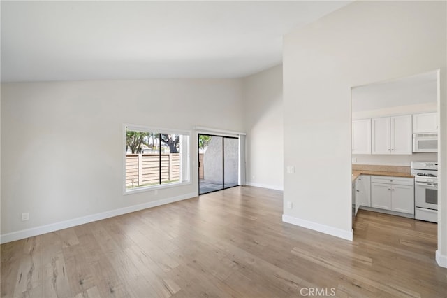 17842 Beard Ln Unit 88, Huntington Beach, CA 92647 - unfurnished living room with light wood-style flooring and high vaulted ceiling