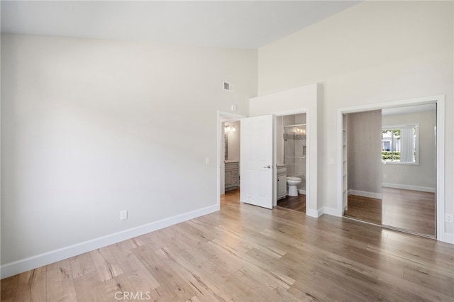 17842 Beard Ln Unit 88, Huntington Beach, CA 92647 - unfurnished bedroom featuring high vaulted ceiling, light wood-style floors, and ensuite bath