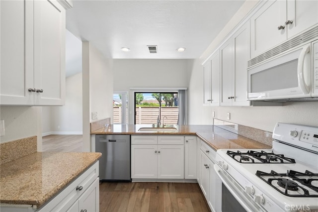 17842 Beard Ln Unit 88, Huntington Beach, CA 92647 - kitchen with white appliances, wood finished floors, white cabinets, and recessed lighting