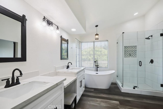 14226 Remington Ct, Fontana, CA 92336 - full bathroom featuring a shower stall, wood finished floors, a soaking tub, two vanities, and recessed lighting
