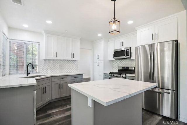 14226 Remington Ct, Fontana, CA 92336 - kitchen with stainless steel appliances, dark wood-style flooring, backsplash, light stone countertops, and gray cabinets
