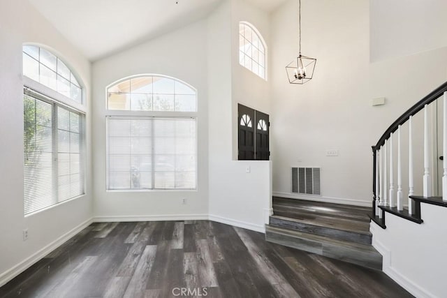 14226 Remington Ct, Fontana, CA 92336 - entrance foyer featuring stairway, healthy amount of natural light, a chandelier, dark wood finished floors, and high vaulted ceiling