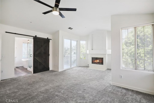 14226 Remington Ct, Fontana, CA 92336 - unfurnished living room with a barn door, healthy amount of natural light, carpet flooring, and vaulted ceiling