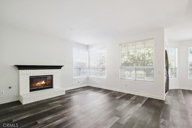 14226 Remington Ct, Fontana, CA 92336 - unfurnished living room with dark wood finished floors and a brick fireplace
