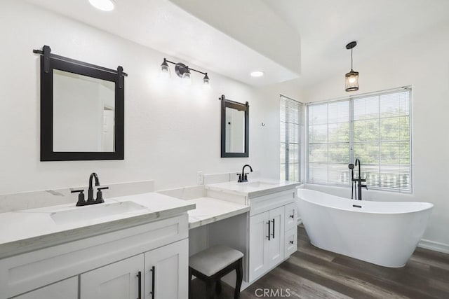 14226 Remington Ct, Fontana, CA 92336 - bathroom with double vanity, wood finished floors, a freestanding bath, and recessed lighting