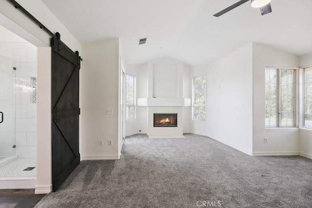 14226 Remington Ct, Fontana, CA 92336 - unfurnished living room featuring a barn door, healthy amount of natural light, carpet floors, ceiling fan, and vaulted ceiling