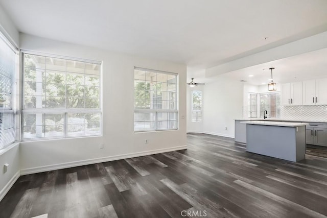 14226 Remington Ct, Fontana, CA 92336 - unfurnished living room featuring dark wood-style flooring and baseboards