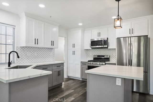 14226 Remington Ct, Fontana, CA 92336 - kitchen featuring appliances with stainless steel finishes, dark wood-style floors, light stone counters, tasteful backsplash, and recessed lighting