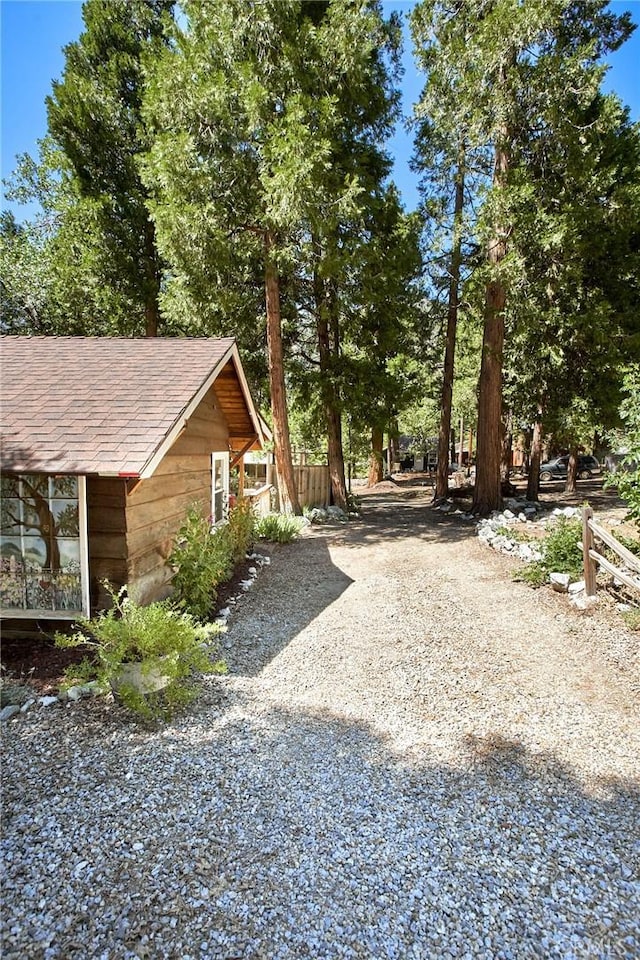41394 Valley Of The Falls Dr, Forest Falls, CA 92339 - view of side of home with roof with shingles and gravel driveway