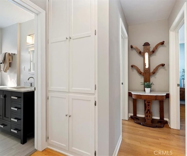 4131 Perlita Ave Unit B, Los Angeles, CA 90039 - hallway with light wood-type flooring and a sink