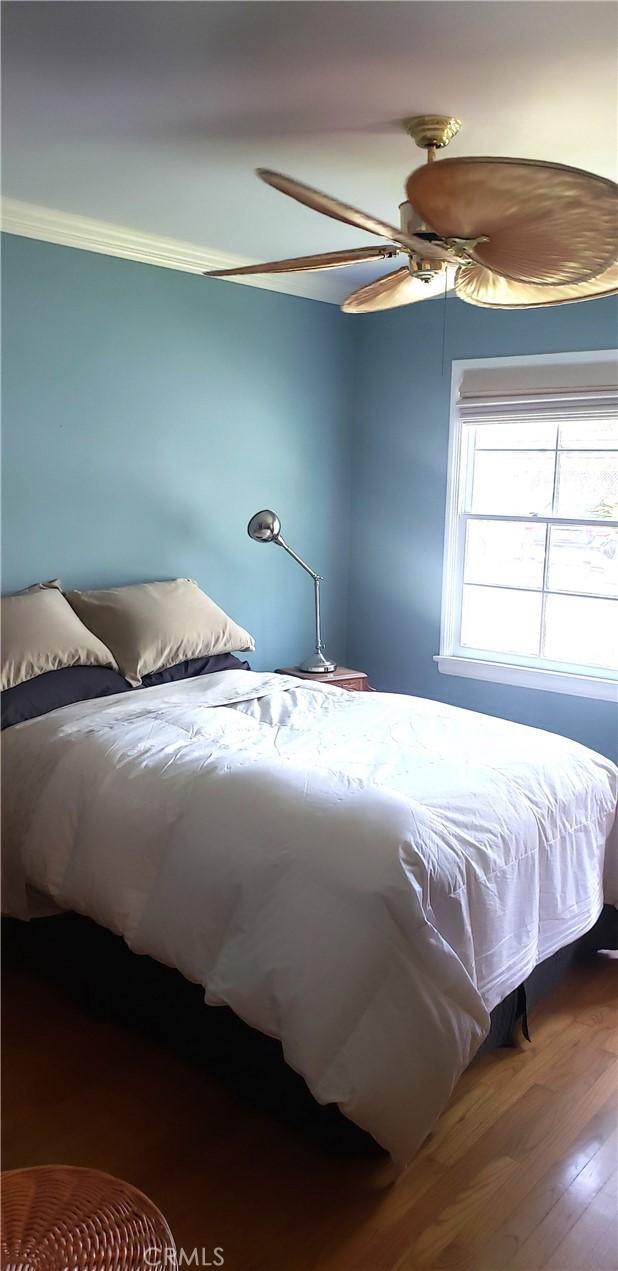 4131 Perlita Ave Unit B, Los Angeles, CA 90039 - bedroom with wood finished floors, a ceiling fan, and ornamental molding