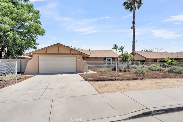 24933 Dracaea Ave, Moreno Valley, CA 92553 - ranch-style house with stucco siding, a garage, a fenced front yard, and driveway