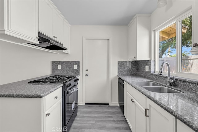 24933 Dracaea Ave, Moreno Valley, CA 92553 - kitchen with black appliances, under cabinet range hood, white cabinets, light wood-style floors, and tasteful backsplash