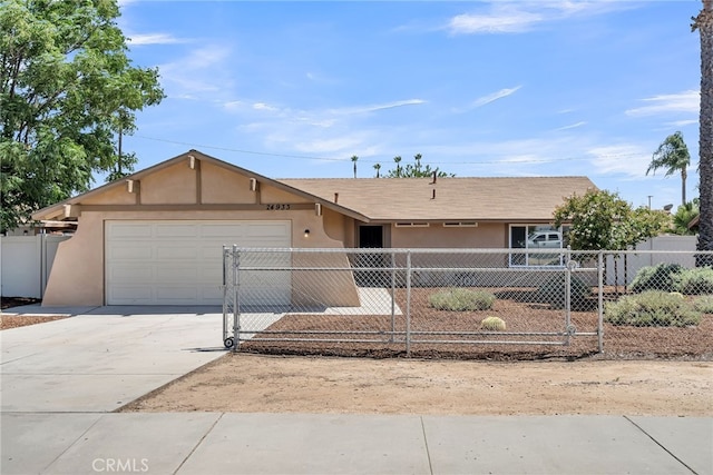 24933 Dracaea Ave, Moreno Valley, CA 92553 - ranch-style home featuring stucco siding, a fenced front yard, and a garage