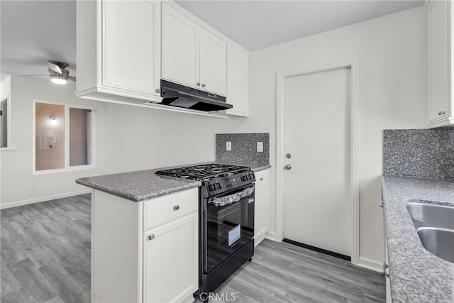 24933 Dracaea Ave, Moreno Valley, CA 92553 - kitchen featuring black range with gas cooktop, light wood-style floors, white cabinets, under cabinet range hood, and ceiling fan