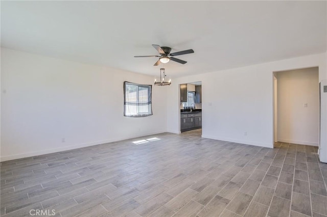 1026 W 109th St, Los Angeles, CA 90044 - empty room featuring a ceiling fan, light wood-style flooring, a chandelier, and a heating unit