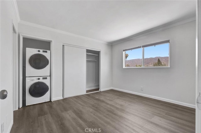 250 W Spazier Ave Unit 209, Burbank, CA 91502 - laundry room with estacked washer and dryer, dark wood-type flooring, and crown molding