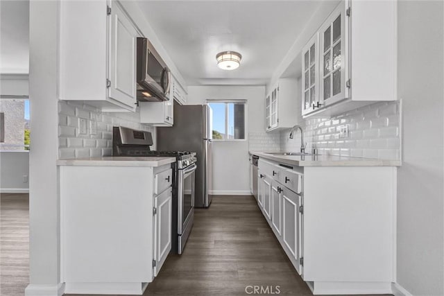 250 W Spazier Ave Unit 209, Burbank, CA 91502 - kitchen featuring stainless steel appliances, tasteful backsplash, light countertops, white cabinets, and dark wood-type flooring