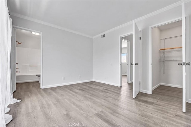 250 W Spazier Ave Unit 209, Burbank, CA 91502 - unfurnished bedroom with crown molding, wood finished floors, a spacious closet, and ensuite bathroom