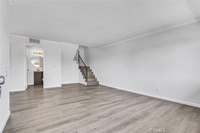 250 W Spazier Ave Unit 209, Burbank, CA 91502 - unfurnished living room featuring stairs, wood finished floors, and ornamental molding