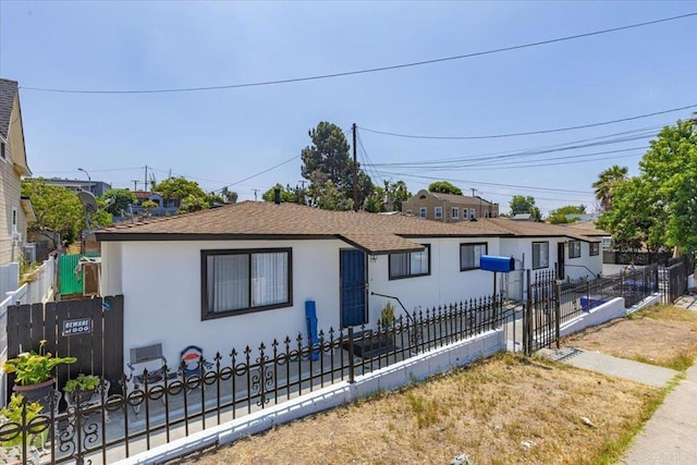 53945 S 36th St, San Diego, CA 92113 - bungalow featuring stucco siding, roof with shingles, and a fenced front yard
