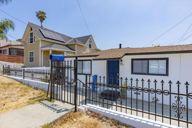 53945 S 36th St, San Diego, CA 92113 - view of front of house with stucco siding, a fenced front yard, and roof with shingles
