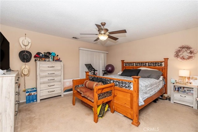 1267 Joshua Tree Dr, Barstow, CA 92311 - bedroom featuring light carpet, ceiling fan, and a textured ceiling