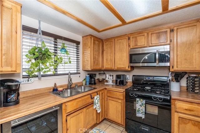 1267 Joshua Tree Dr, Barstow, CA 92311 - kitchen featuring black gas stove, stainless steel microwave, light countertops, dishwasher, and light tile patterned flooring