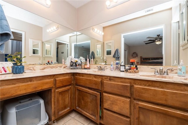 1267 Joshua Tree Dr, Barstow, CA 92311 - full bathroom with tile patterned floors, double vanity, a ceiling fan, and ensuite bath