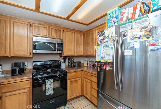 1267 Joshua Tree Dr, Barstow, CA 92311 - kitchen with appliances with stainless steel finishes, light tile patterned floors, and light countertops