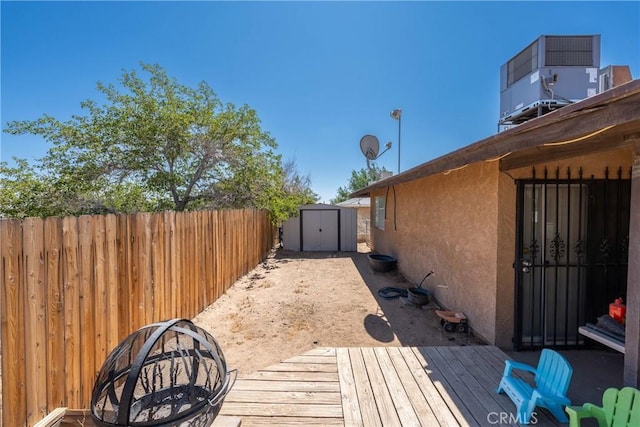 1267 Joshua Tree Dr, Barstow, CA 92311 - fenced backyard featuring a storage shed and a deck