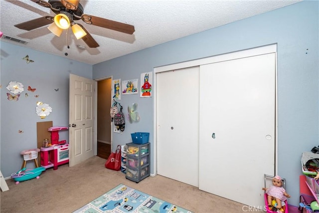 1267 Joshua Tree Dr, Barstow, CA 92311 - rec room with carpet floors, a ceiling fan, and a textured ceiling