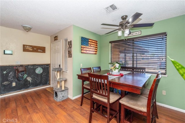 1267 Joshua Tree Dr, Barstow, CA 92311 - dining area featuring a ceiling fan, wood finished floors, and a textured ceiling