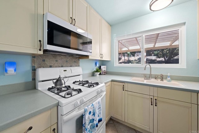 4562 Golden Ridge Dr, Oceanside, CA 92056 - kitchen featuring white gas stove, plenty of natural light, light countertops, and decorative backsplash