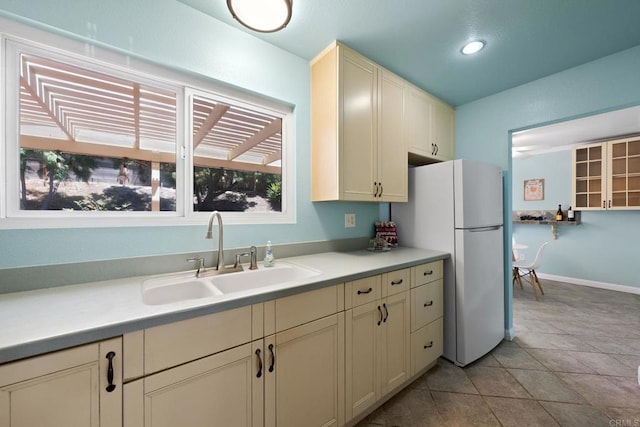 4562 Golden Ridge Dr, Oceanside, CA 92056 - kitchen featuring freestanding refrigerator, cream cabinetry, light countertops, light tile patterned floors, and recessed lighting