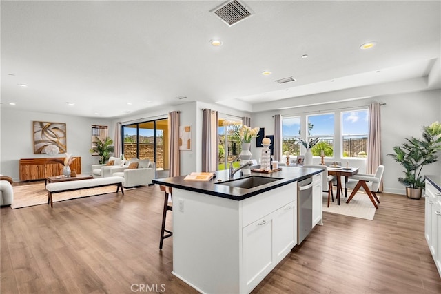 19162 Lauren Ln, Saugus, CA 91350 - kitchen with dark countertops, dishwasher, open floor plan, a kitchen island with sink, and recessed lighting