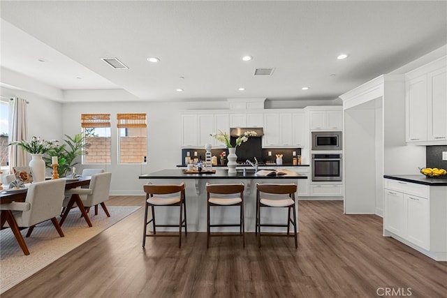19162 Lauren Ln, Saugus, CA 91350 - kitchen with appliances with stainless steel finishes, dark countertops, tasteful backsplash, dark wood-style flooring, and recessed lighting